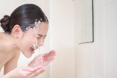 A beautiful woman is washing her face