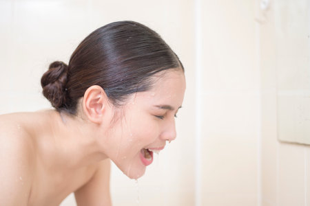 A beautiful woman is washing her face