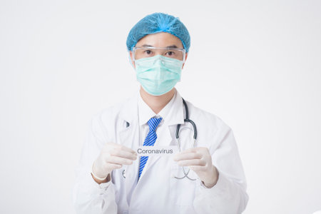 Doctor is holding Coronavirus card on white backgroundの写真素材