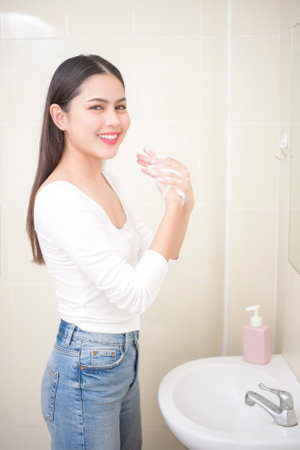 A woman is washing hands