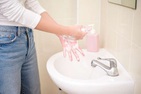 A woman is washing handsの写真素材