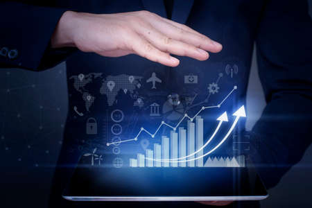 Businessman is holding financial growth graph and analyzing business data, business plan and...
