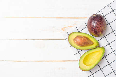 Avocado on white wooden table