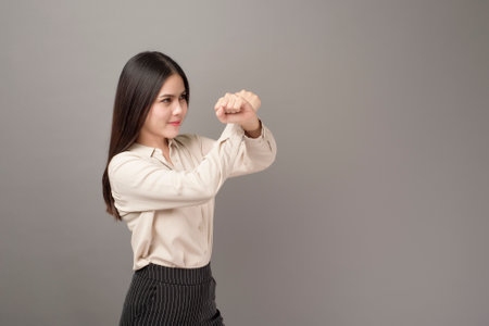 Beautiful Business woman is protecting business on gray backgroundの写真素材