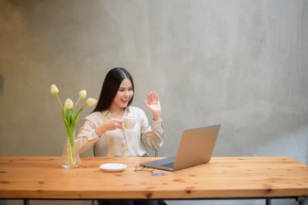 Beautiful business woman is working with laptop in coffee shopの写真素材