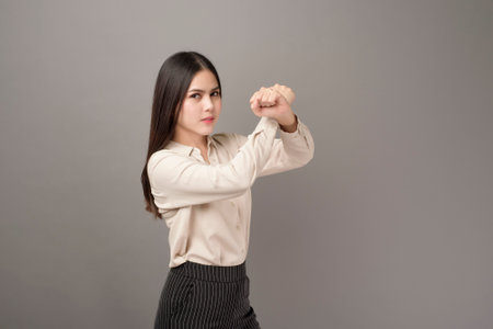 Beautiful Business woman is protecting business on gray backgroundの写真素材