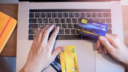Woman hand is holding credit card, shopping online