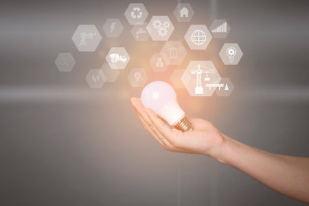 Close up human hand is holding Light bulb with engineering technology on virtual screen