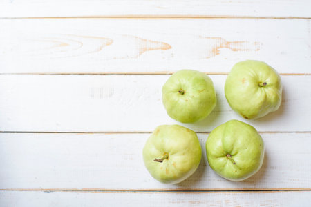 Guavas on white wooden table.の写真素材