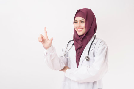 Beautiful woman doctor with hijab portrait on white backgroundの写真素材