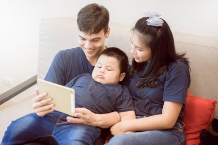 Happy family are enjoying on sofa at home, Safety home activity concept