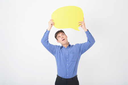 A Caucasian Middle aged Man is holding yellow empty speech on white background