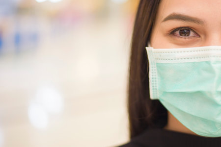 Close up  of woman is wearing surgical mask in shopping center