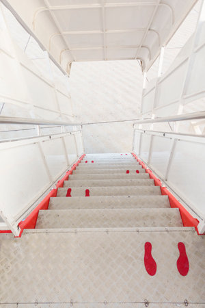 foot sign on airplane corridor, Social distancing protocol on aviation , New normal travel and transportation conceptの写真素材