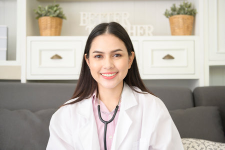 Portrait of Female doctor with stethoscope at office and smiling at camera.の写真素材