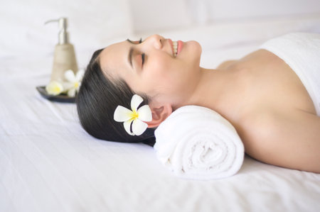 A beautiful woman is relaxing and having massage in spa resort, Massage and beauty treatment...