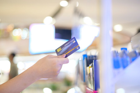 Close up hand using credit card in mall backgroundの写真素材