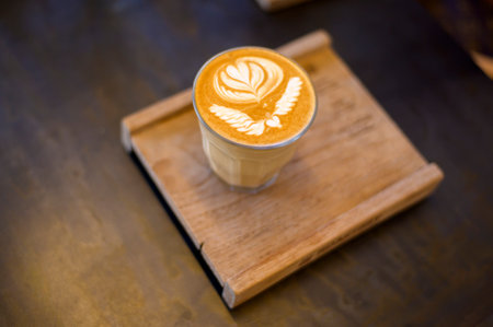 top view of cup of hot latte art on wooden table backgroundの写真素材