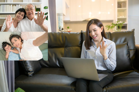 A young asian woman is using laptop computer to Video calling or Webcam to greeting her family  , ...