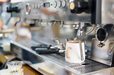 coffee machine making black coffee and pouring into a cup at cafeの写真素材