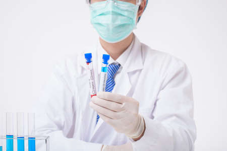 close up of cientist is testing and researching some blue liquid chemical in laboratory isolated...