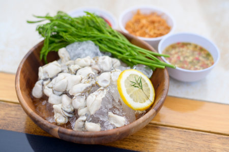 A fresh oysters served in a plate with thai spicy seafood sauce