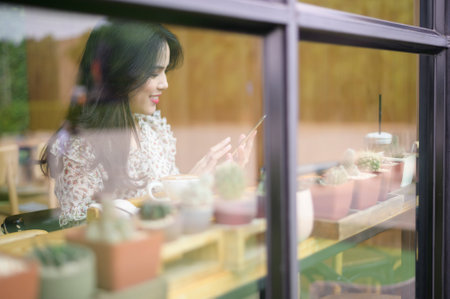 A young beautiful woman is working in coffee shop .