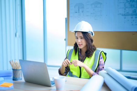 A female engineer using laptop, making video call to client or business partner