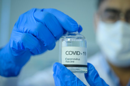 A scientist holding liquid chemical tube in laboratory, Science and technology healthcare conceptの写真素材
