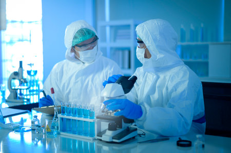 A scientist using microscope during experiment in laboratory, Science and technology healthcare conceptの写真素材