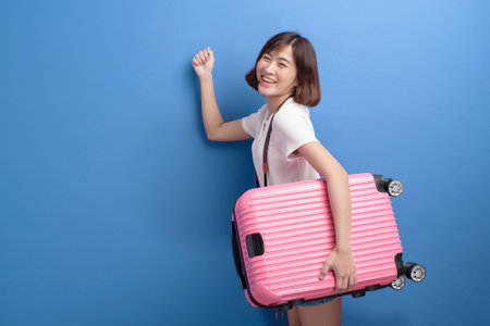 A portrait of young female traveler isolated over purple background studio.の写真素材