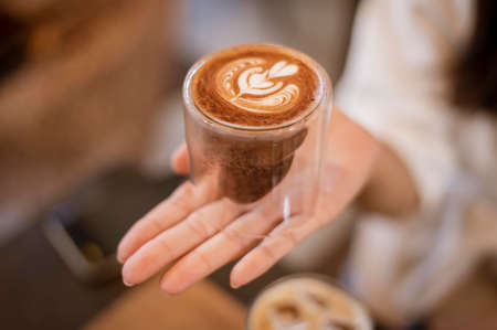 A young happy woman enjoying and relaxing in coffee shop