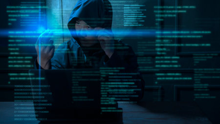 A Hacker is using laptop computer to steal data in the night