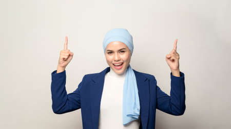 A close up of young beautiful muslim businesswoman with hijab isolated on white background studioの写真素材