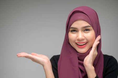 A portrait of young muslim woman over white background studioの写真素材