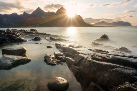 A beautiful view of mountains and beach in Lofoten Islands at sunset