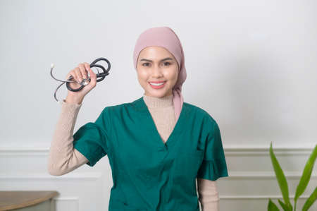 A portrait of Female muslim doctor with stethoscope at office.の写真素材