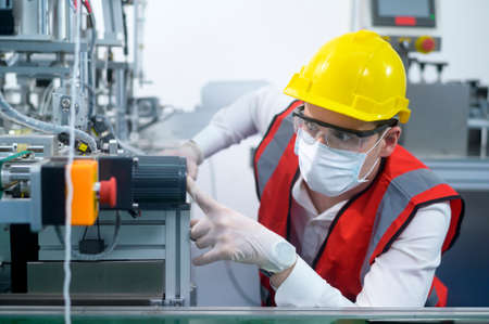 Quality control (QC) engineer monitoring and checking machine system in manufacturing factoryの写真素材
