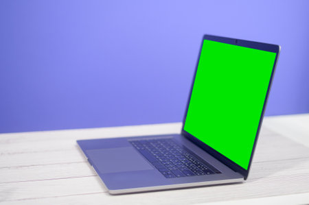 Laptop computer on desk over blue background