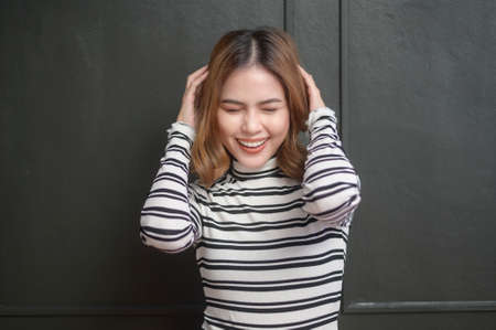 A portrait of young beautiful short hair woman over black background