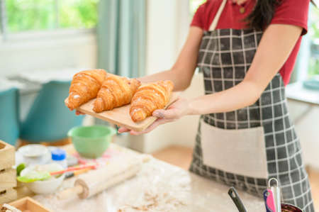 A young beautiful Asian woman is baking in her kitchen  , bakery and coffee shop business