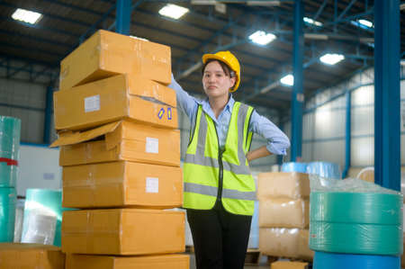 An Asian engineering  woman is working  in modern warehouse