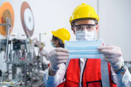 Quality control (QC) engineer monitoring and checking machine system in manufacturing factoryの写真素材