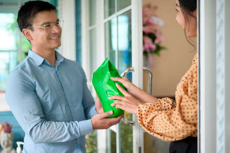 Business owners are analyzing business data , talking and smiling in modern shopの写真素材