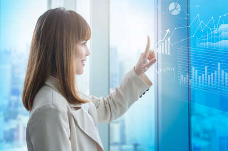 A young business woman hand touching on virtual screen