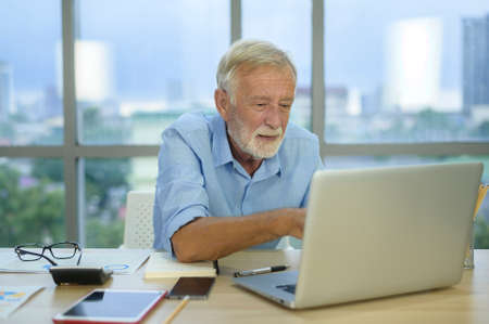 A caucasian senior Businessman working in modern office