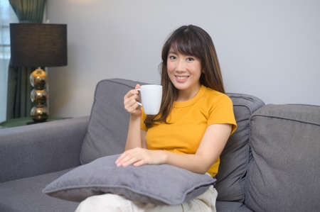 A portrait of young beautiful woman having a cup of coffee