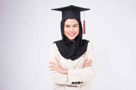 Young muslim woman graduated over white background studio.の写真素材
