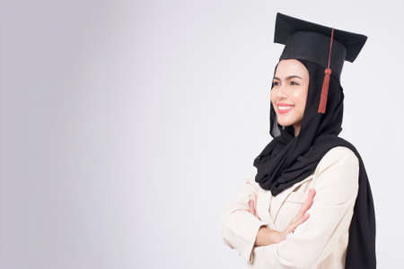 Young muslim woman graduated over white background studio.の写真素材