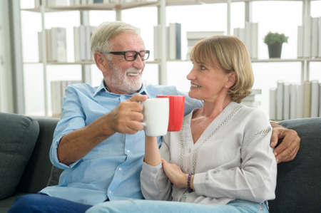 Happy Caucasian seniors couple are drinking coffee in home , relaxing and health care concept .